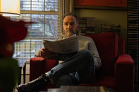 Writer George Pelecanos reads <em>The</em> <em>Washington Post</em> every morning in his home.