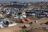 Displaced Palestinians take shelter in a makeshift tent camp by the beach in Rafah near the border with Egypt in the southern Gaza Strip on Tuesday, amid the ongoing conflict between Israel and the Palestinian militant group Hamas.