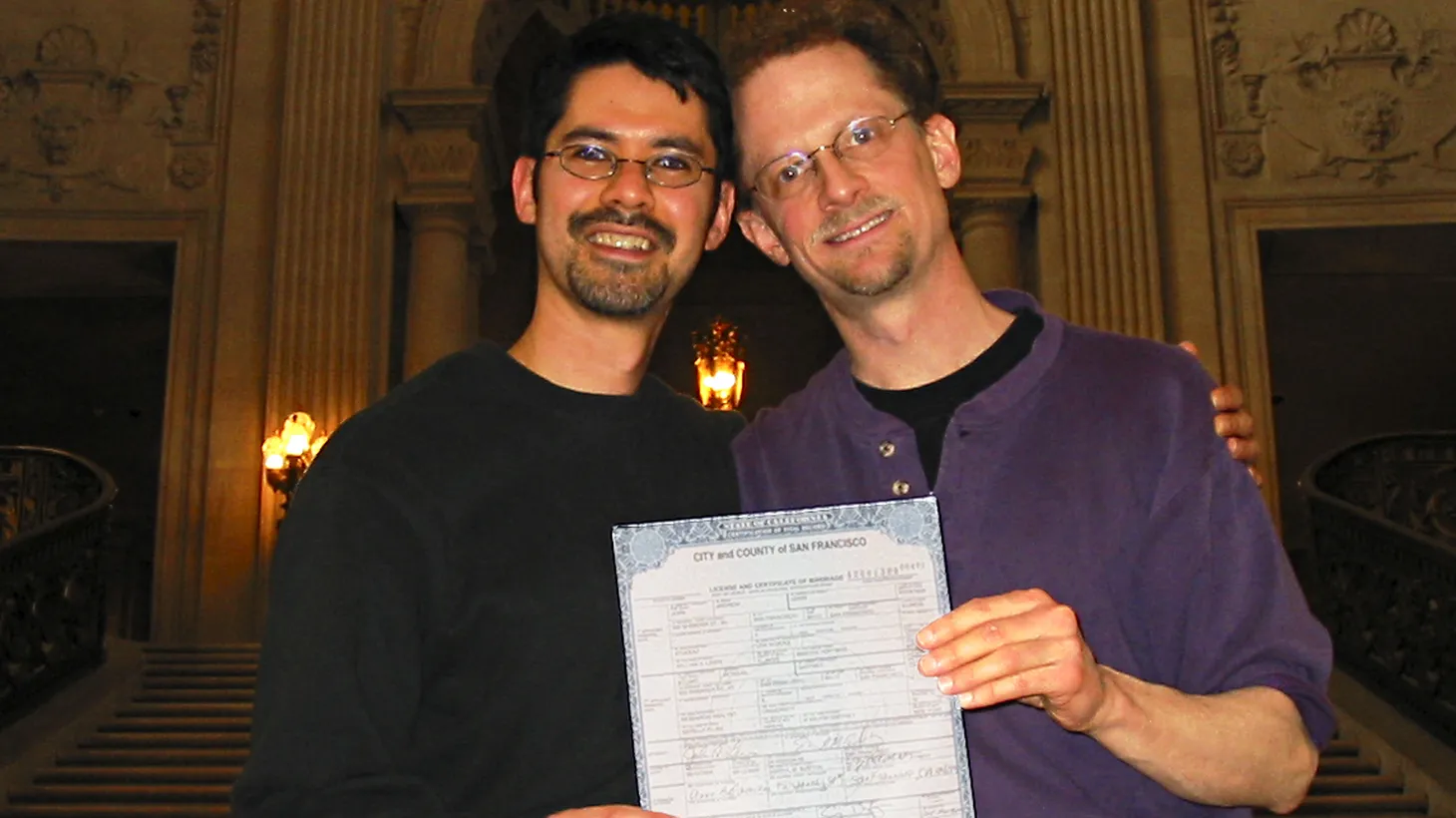 Stuart Gaffney (left) and John Lewis (right) hold up their marriage certificate on Feb. 12, 2004.